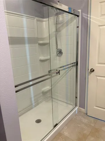 a bathroom with a glass shower door