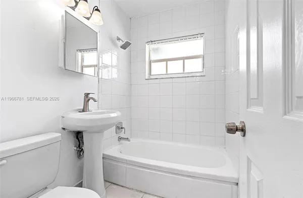 a white bath tub sitting next to a white sink