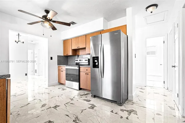 a kitchen with stainless steel appliances a refrigerator sink and cabinets