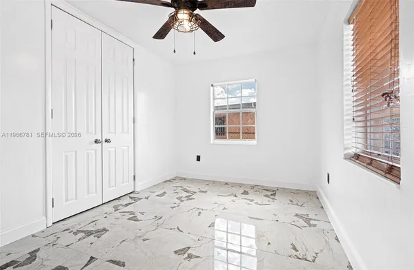 a view of a livingroom with wooden floor and windows