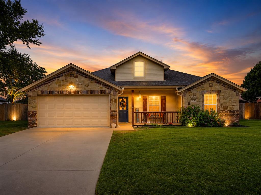 Stone and brick facade with an attached two-car garage.