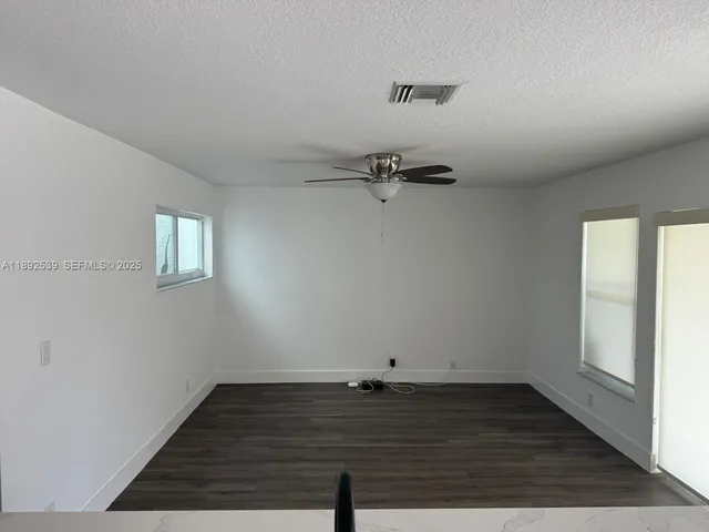 a view of a room with wooden floor and window