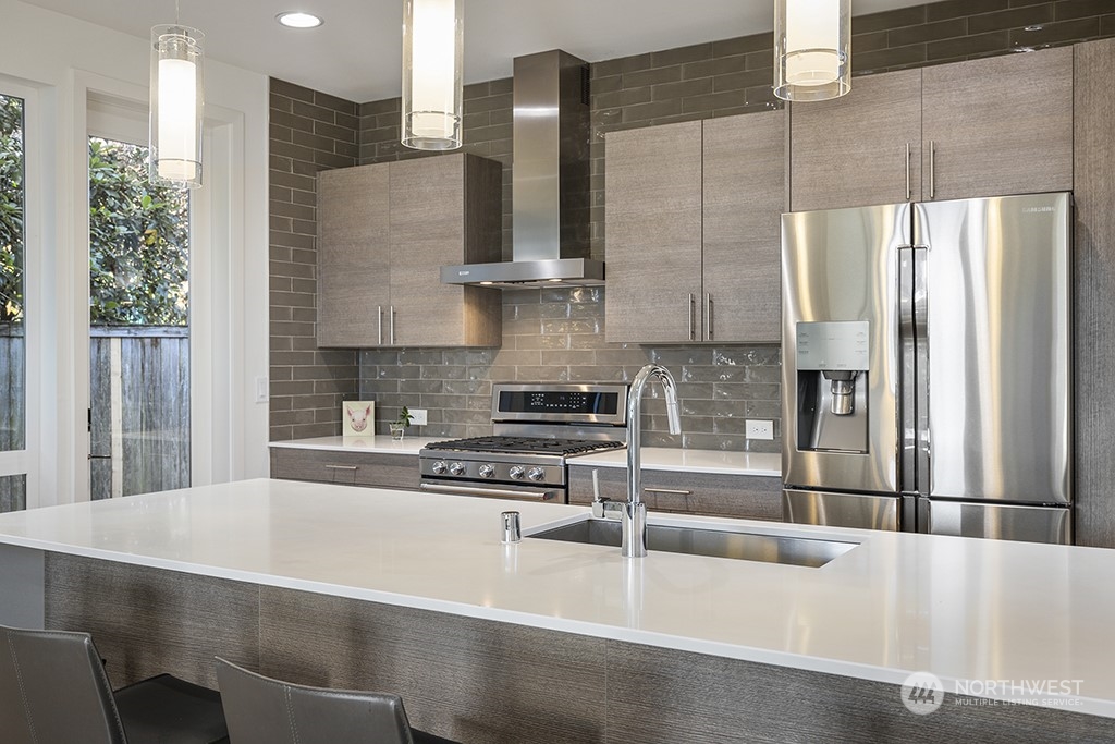 1406 South Bennett Street Seattle, WA 98108 - Photo 13 of 36 a kitchen with stainless steel appliances a refrigerator and a sink