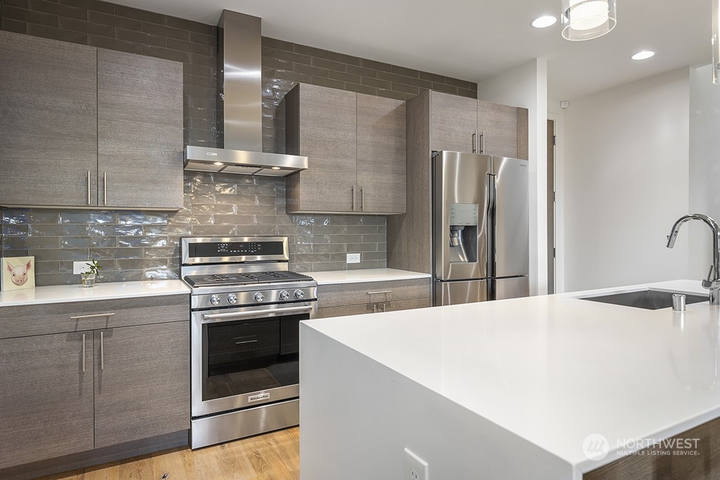 1406 South Bennett Street Seattle, WA 98108 - Photo 14 of 36 a kitchen with stainless steel appliances a stove and a refrigerator