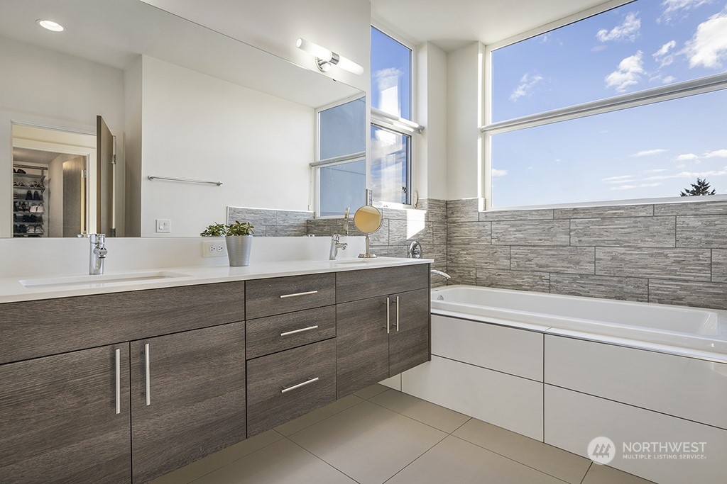 1406 South Bennett Street Seattle, WA 98108 - Photo 18 of 36 a spacious bathroom with a granite countertop sink a mirror and a