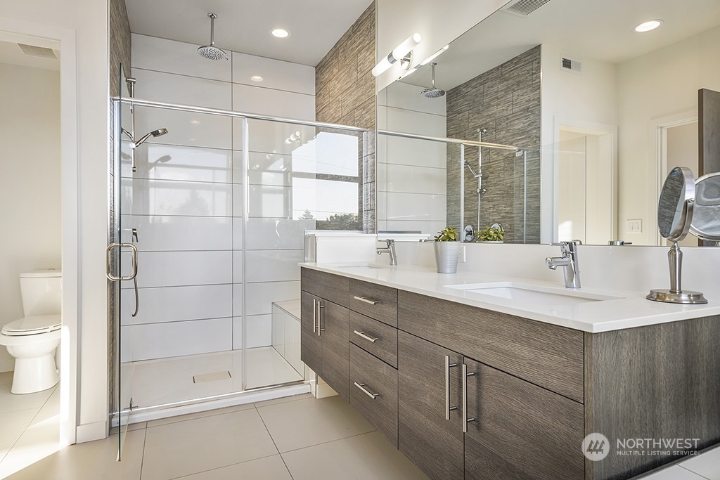 1406 South Bennett Street Seattle, WA 98108 - Photo 19 of 36 a bathroom with a shower sink and mirror