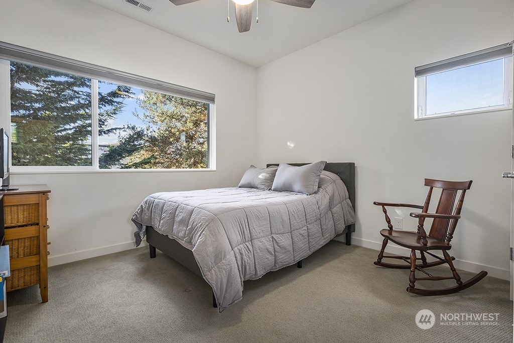 1406 South Bennett Street Seattle, WA 98108 - Photo 20 of 36 a spacious bedroom with a bed chair and window