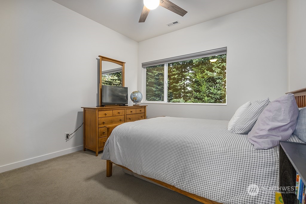 1406 South Bennett Street Seattle, WA 98108 - Photo 21 of 36 a bedroom with a bed and a chandelier