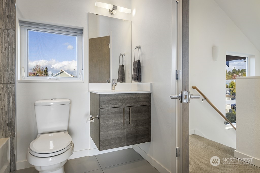 1406 South Bennett Street Seattle, WA 98108 - Photo 28 of 36 a bathroom with a toilet sink and mirror
