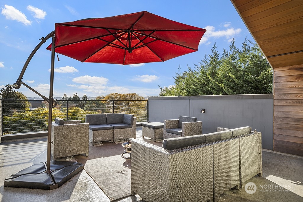 1406 South Bennett Street Seattle, WA 98108 - Photo 3 of 36 a view of a terrace with furniture and umbrella