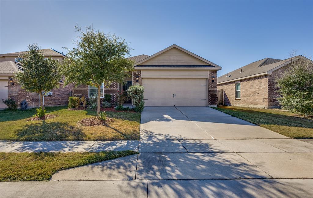 1707 Hot Springs Way Princeton, TX 75407 - Photo 2 of 12 a front view of a house with a yard and garage