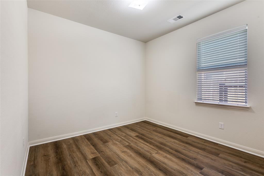 1707 Hot Springs Way Princeton, TX 75407 - Photo 8 of 12 a view of empty room with wooden floor and fan