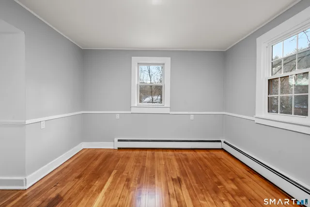 wooden floor in an empty room with a window