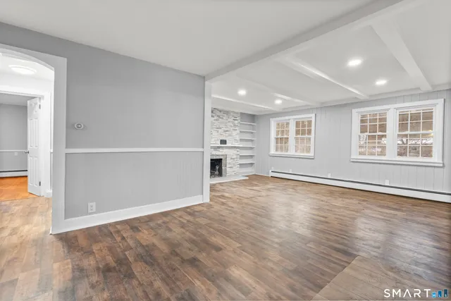 wooden floor in an empty room with a window