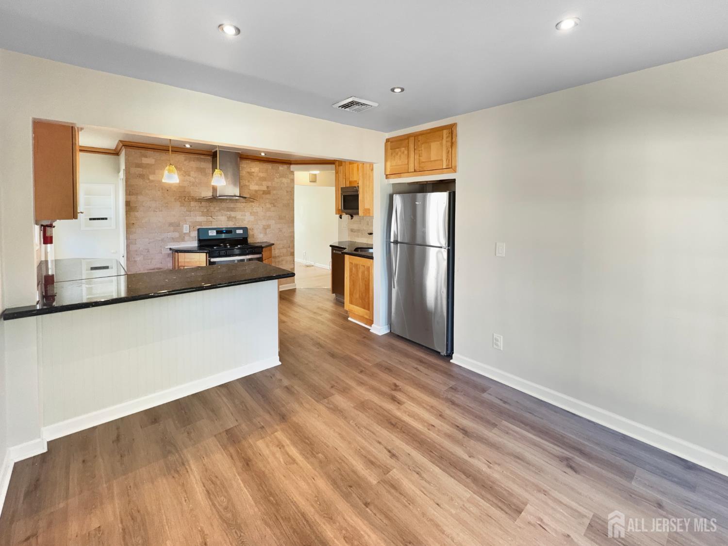 124 Lincoln Avenue Colonia, NJ 07067 - Photo 12 of 21 a large kitchen with a refrigerator a stove a microwave and cabinets