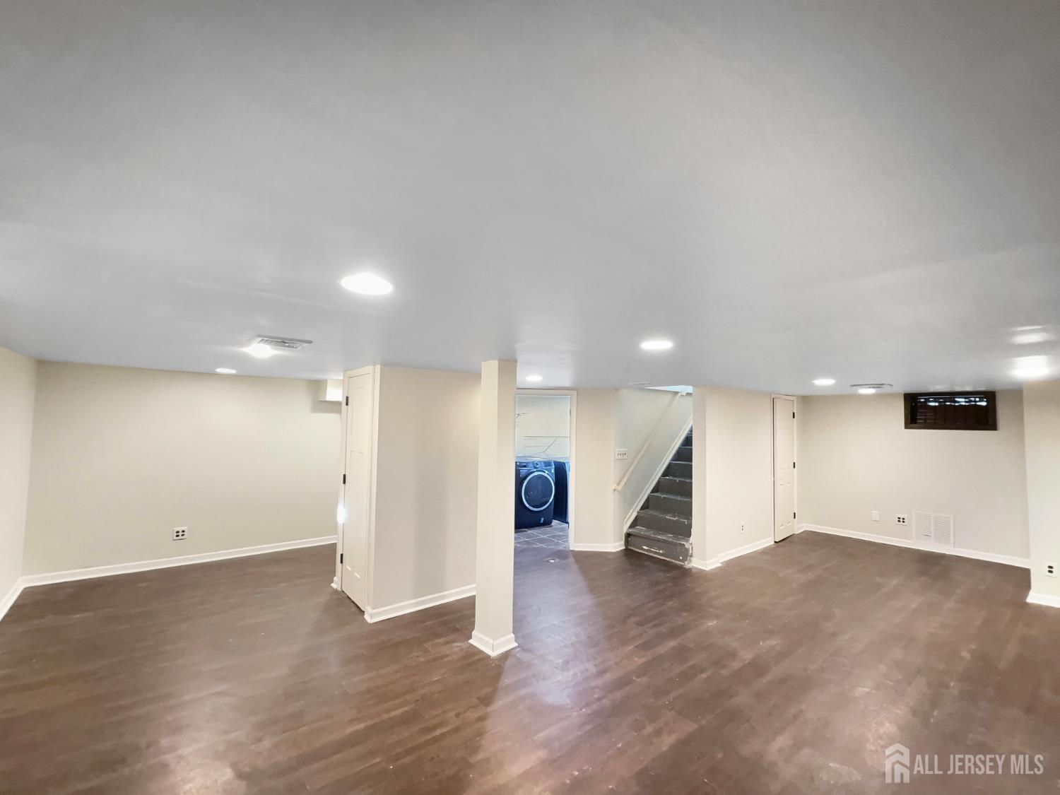 124 Lincoln Avenue Colonia, NJ 07067 - Photo 18 of 21 an empty room with wooden floor and entryway