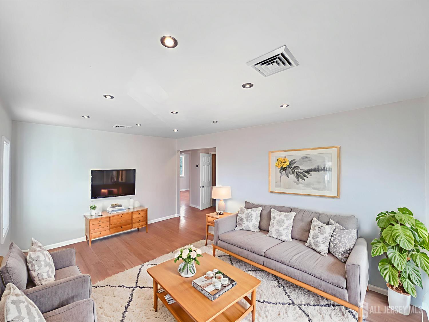 124 Lincoln Avenue Colonia, NJ 07067 - Photo 2 of 21 a living room with furniture and a flat screen tv