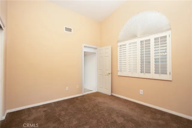 an aerial view of residential houses with outdoor space and parking