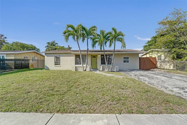 a front view of house with yard and trees