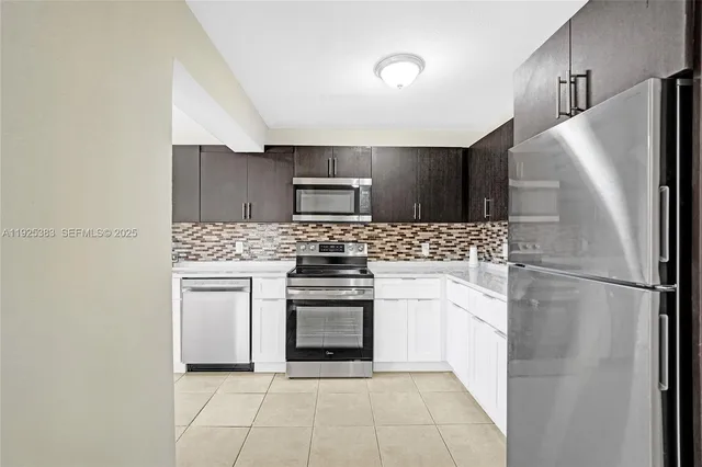 a kitchen with a sink cabinets and appliances