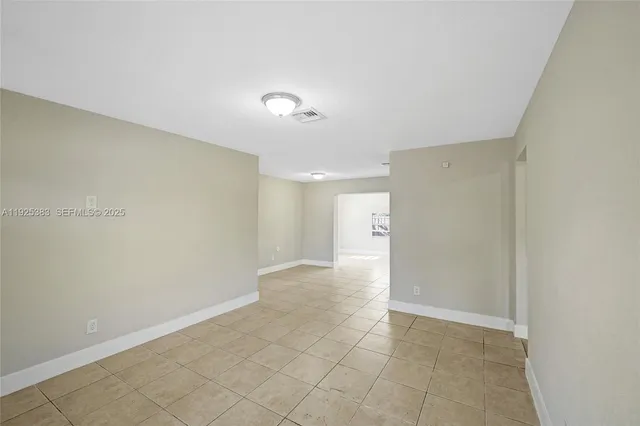 a view of an empty room and a window