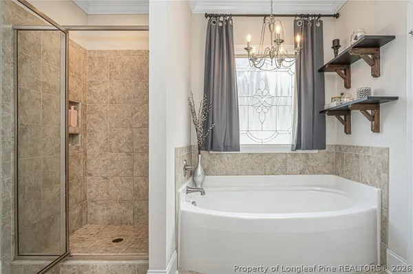 a white bath tub sitting next to a shower