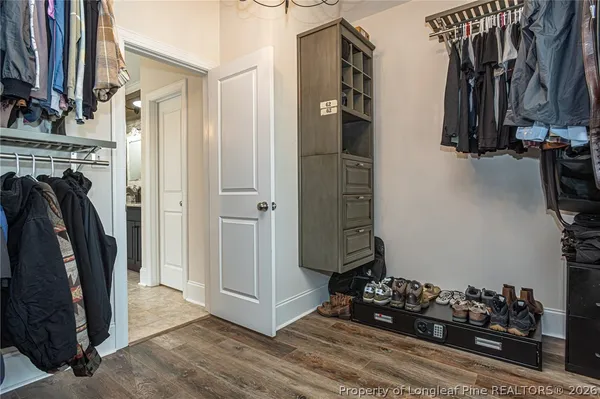 a view of walk in closet with clothes and shoes