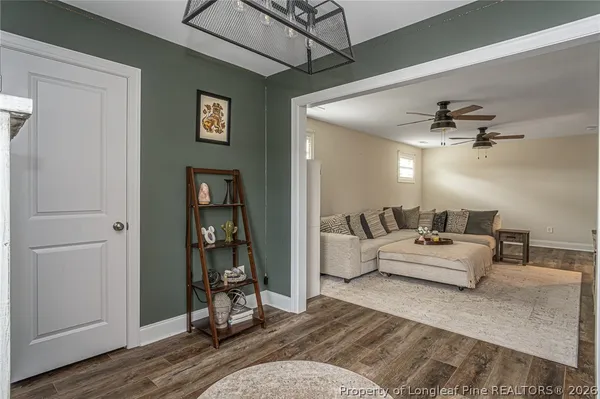 a living room with furniture and wooden floor