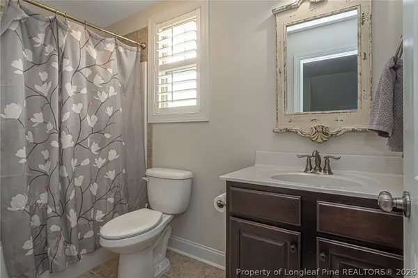 a bathroom with a sink toilet and mirror