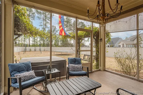 a living room with furniture and a floor to ceiling window