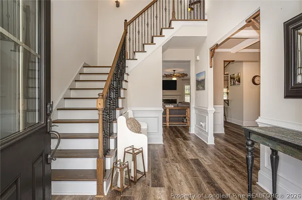 a view of entryway and hall with wooden floor