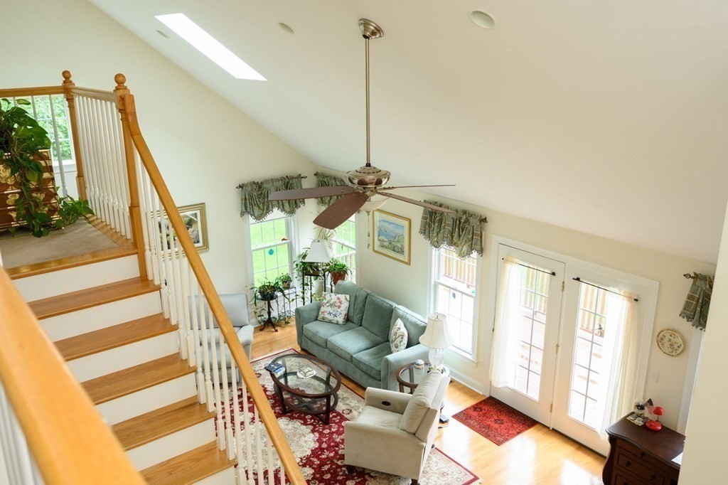 25 Hemlock Circle, Unit 25 Hanover, MA 02339 - Photo 12 of 36 a living room with furniture and a floor to ceiling window