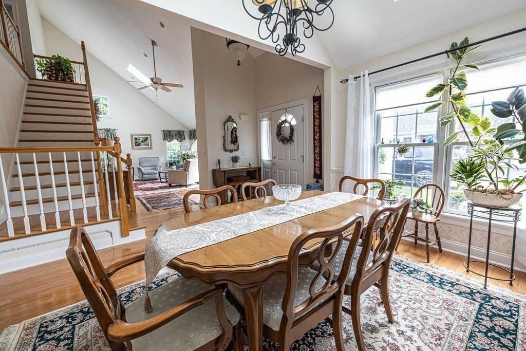 25 Hemlock Circle, Unit 25 Hanover, MA 02339 - Photo 15 of 36 a dining room with furniture a chandelier and wooden floor