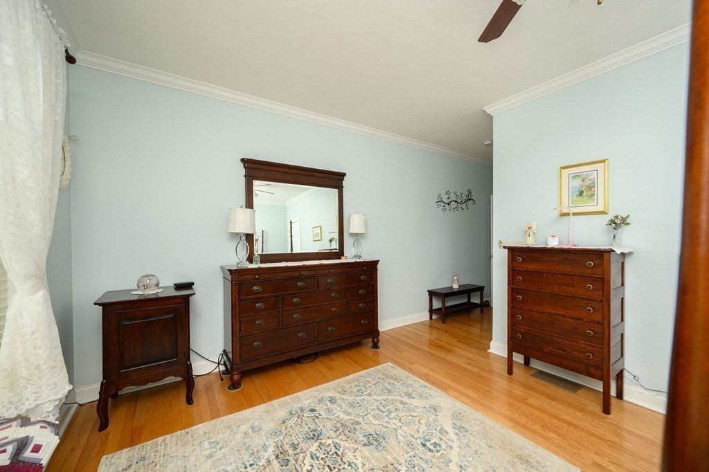 25 Hemlock Circle, Unit 25 Hanover, MA 02339 - Photo 22 of 36 a room with a dresser and a chair