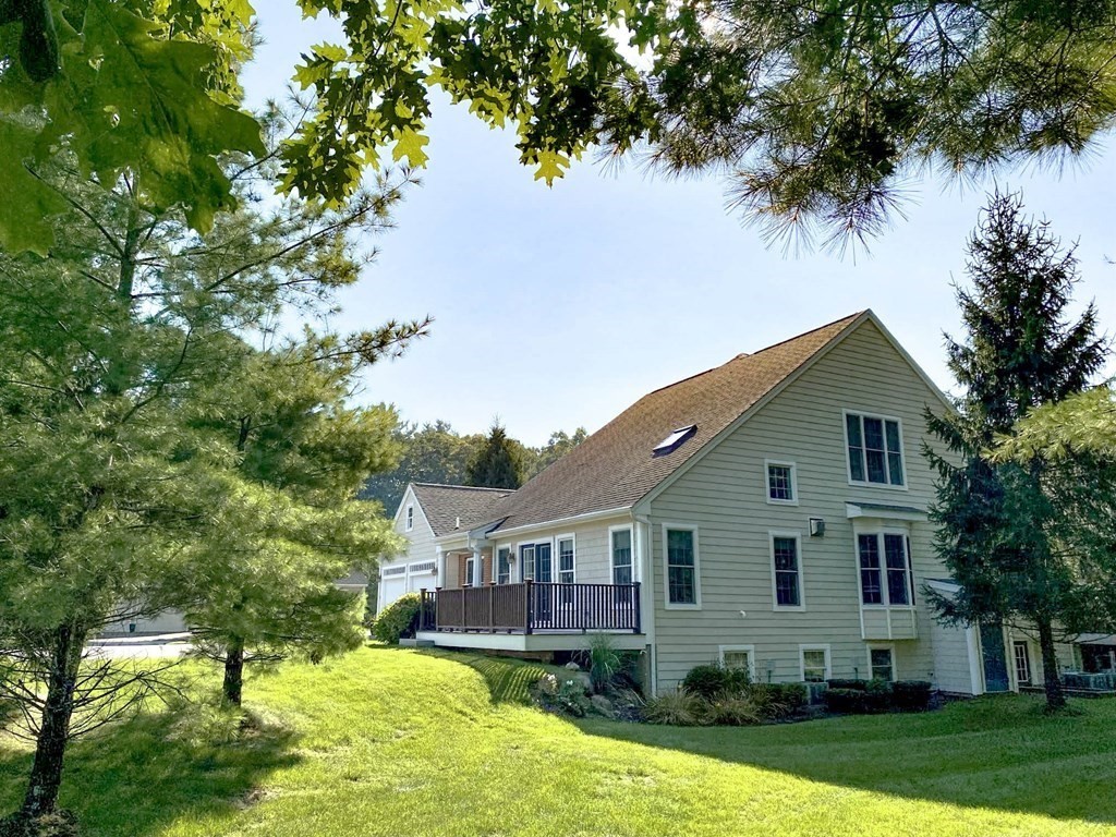 25 Hemlock Circle, Unit 25 Hanover, MA 02339 - Photo 3 of 36 a front view of a house with a yard and garage