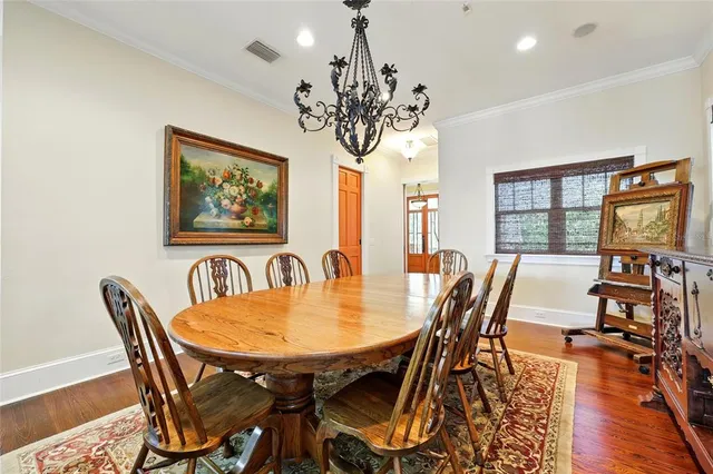 a view of a dining room with furniture wooden floor and a potted plant
