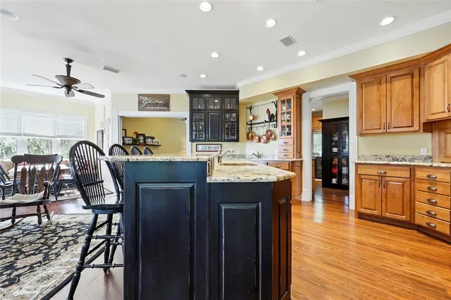 a kitchen with stainless steel appliances granite countertop a refrigerator and a stove top oven