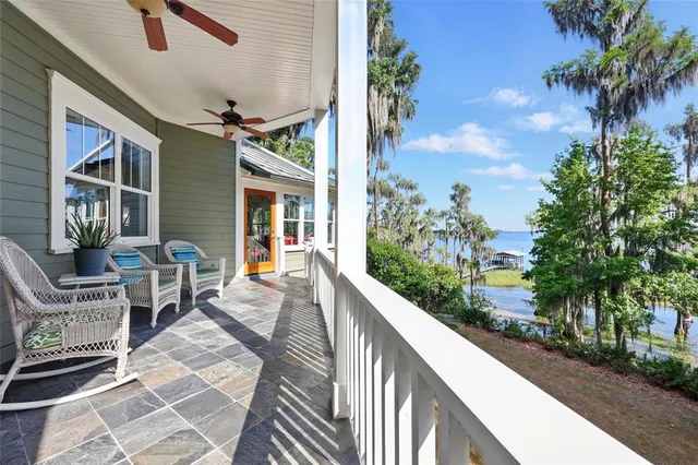a view of balcony with wooden floor and fence