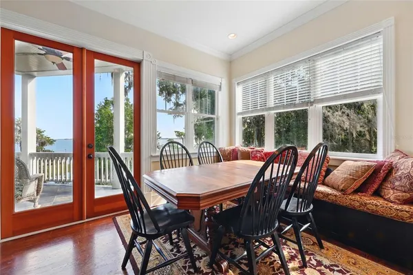 a bedroom with a bed couch and a large window