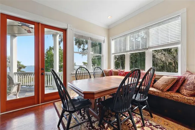 a bedroom with a bed couch and a large window