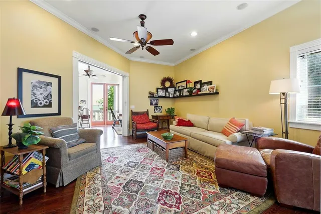 a living room with furniture and wooden floor