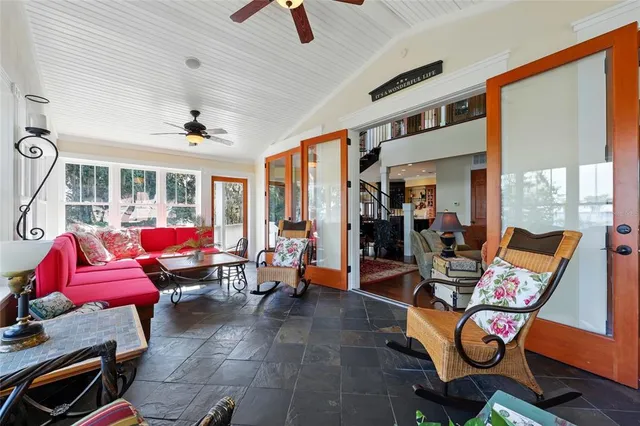 a living room with furniture wooden floor and window
