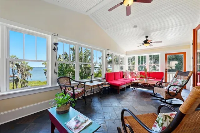 a dining room with furniture a chandelier and wooden floor