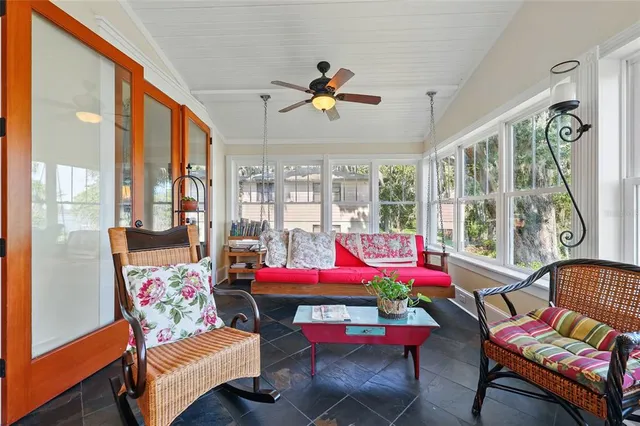 a room with furniture pool table wooden floor and windows