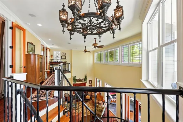 a living room with furniture kitchen view and a wooden floor