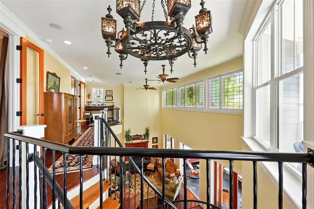 a living room with furniture kitchen view and a wooden floor