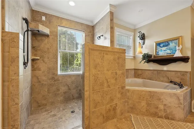 a bathroom with a glass door shower and a sink