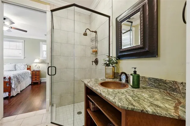 a bathroom with a glass shower door and a mirror