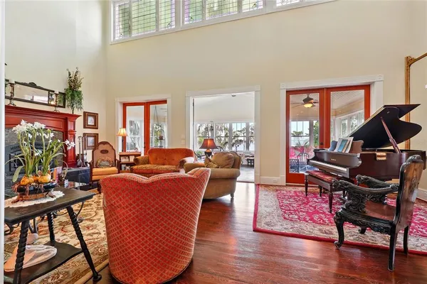 a view of a dining room with furniture a chandelier and wooden floor
