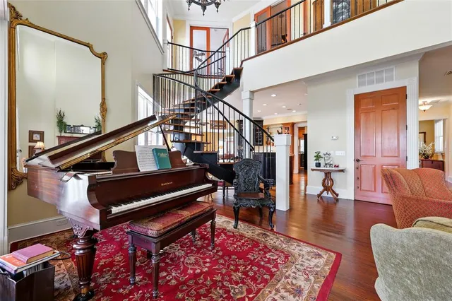 a kitchen with stainless steel appliances granite countertop a stove a sink and a wooden floors